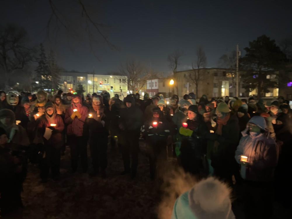 A gathering of people holding candles