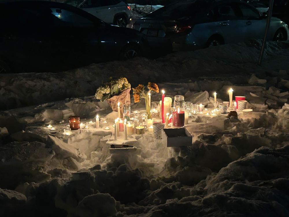 Flowers and candles placed on top of snow