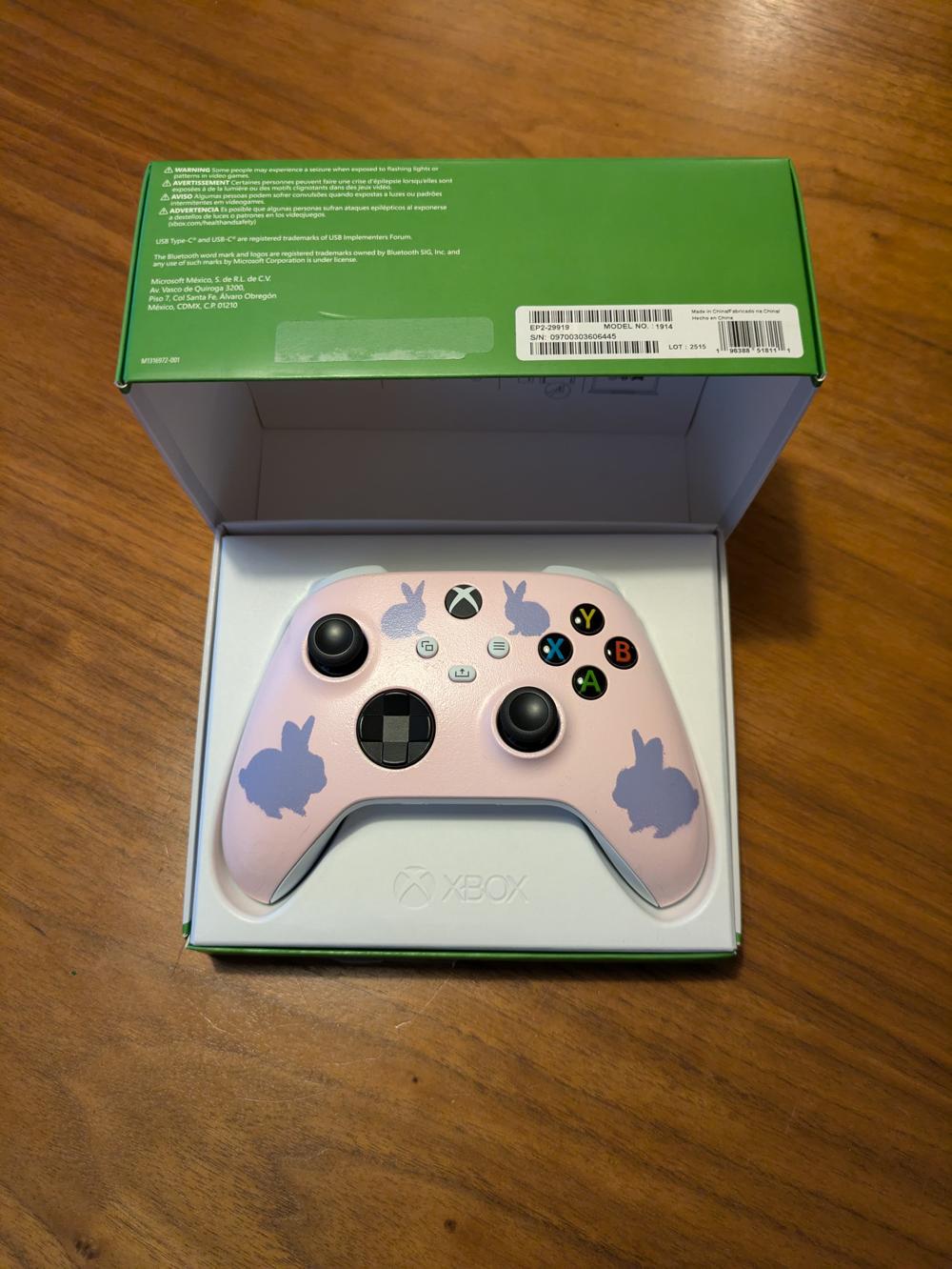 The spray painted xbox controller sitting in it's original product box