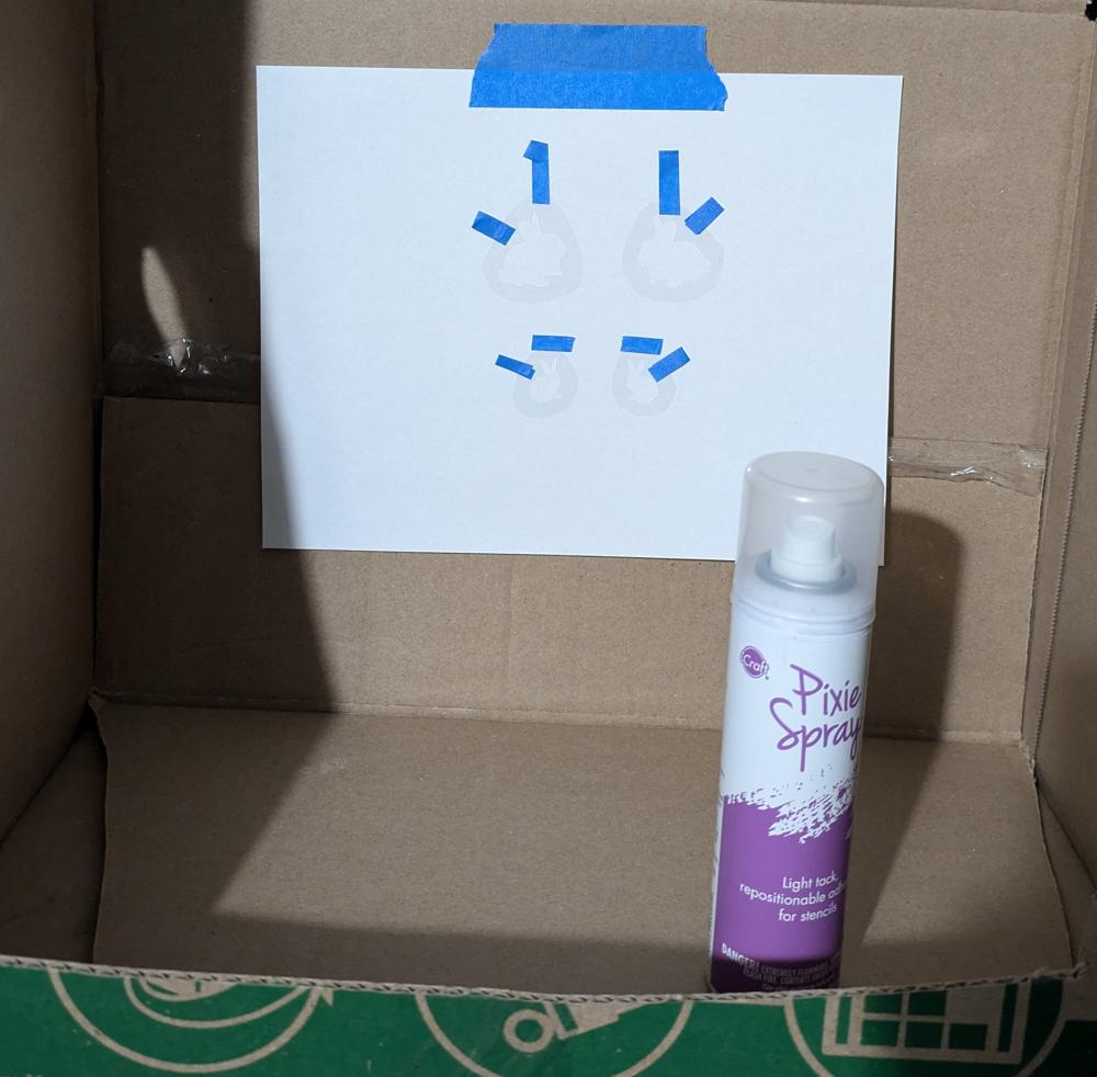Stencils next to adhesive spray can