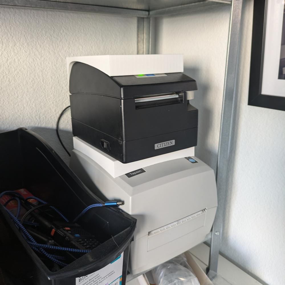 receipt printer sitting on top of another thermal printer