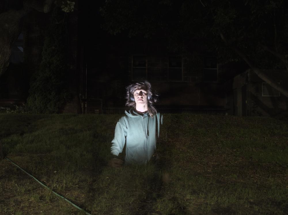 A bright floating upper portion of myself on a dark background