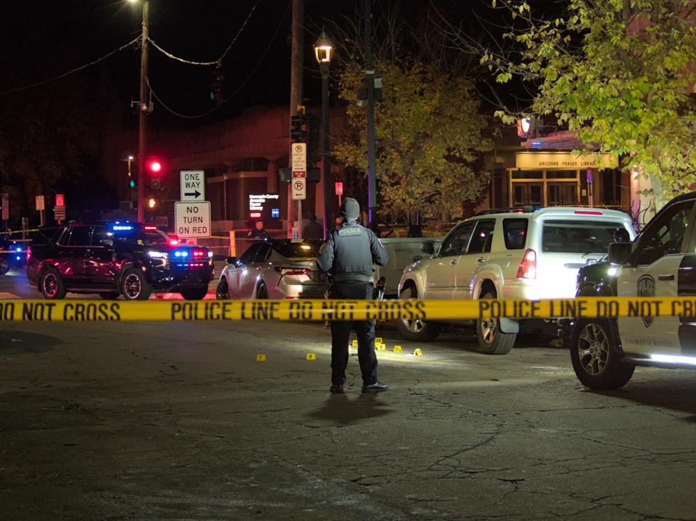 a policeman standing a crime scene behind yellow caution tape
