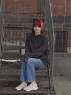 My partner who is a very cool looking person sitting on stairs