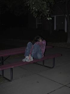 Me curled up on bench
